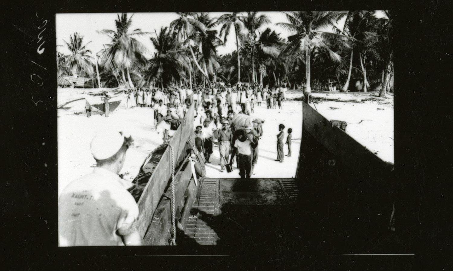 Residents of Bikini Atoll in the Marshall Islands board landing craft