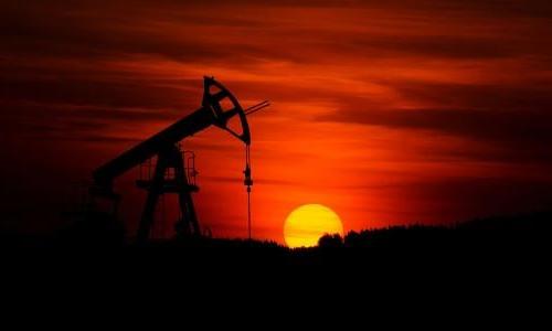 pump jack mining crude oil with sunset